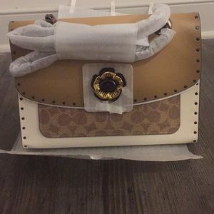 Brand new coach purse. Tan with coach emblem.